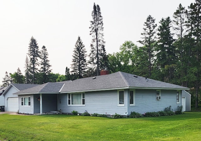 505 Lindquist St W, Onamia, MN 56359 - rear view of property with a lawn, a garage, a chimney, and a shingled roof