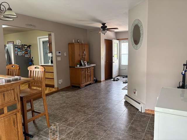 505 Lindquist St W, Onamia, MN 56359 - dining area featuring a baseboard radiator, a ceiling fan, and baseboards