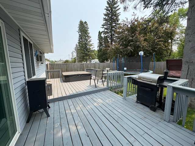 505 Lindquist St W, Onamia, MN 56359 - deck featuring a trampoline, a covered hot tub, and a fenced backyard