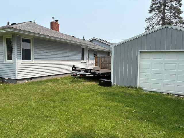 505 Lindquist St W, Onamia, MN 56359 - rear view of property with a chimney, roof with shingles, and an outbuilding