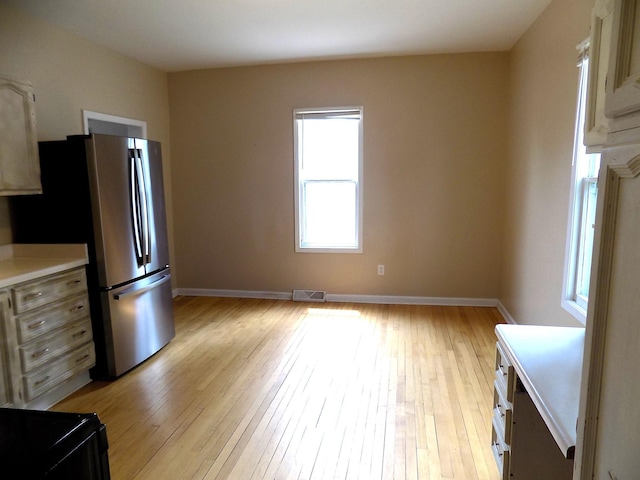 101 1st St SE, Baudette, MN 56623 - kitchen with freestanding refrigerator, light wood-style floors, light countertops, and baseboards