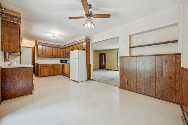4399 124th Ave, Clear Lake, MN 55319 - kitchen featuring freestanding refrigerator, brown cabinets, ceiling fan, light countertops, and a sink
