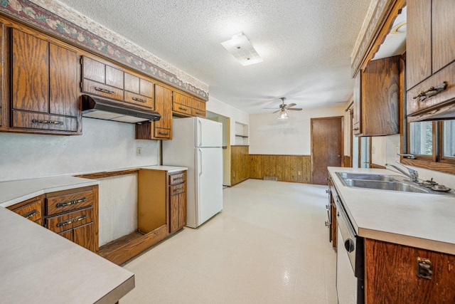 4399 124th Ave, Clear Lake, MN 55319 - kitchen featuring freestanding refrigerator, under cabinet range hood, a wainscoted wall, a sink, and a ceiling fan
