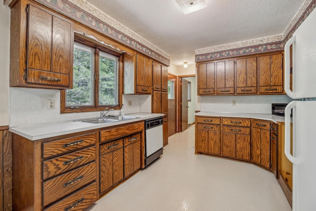 4399 124th Ave, Clear Lake, MN 55319 - kitchen with a sink, white appliances, a textured ceiling, light countertops, and brown cabinetry