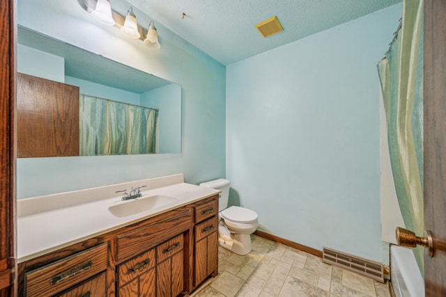 4399 124th Ave, Clear Lake, MN 55319 - full bathroom with vanity, toilet, baseboards, and a textured ceiling