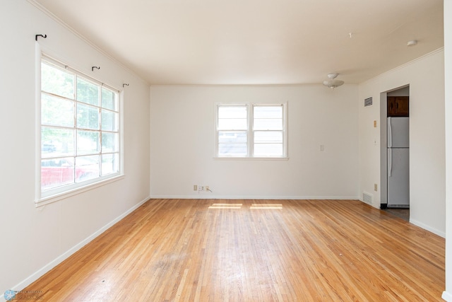 1614 2nd St N, Fargo, ND 58102 - spare room with light wood-type flooring, crown molding, baseboards, and a smoke detector