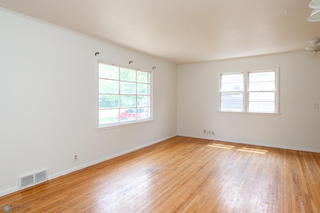 1614 2nd St N, Fargo, ND 58102 - unfurnished room featuring light wood-style flooring, baseboards, and crown molding