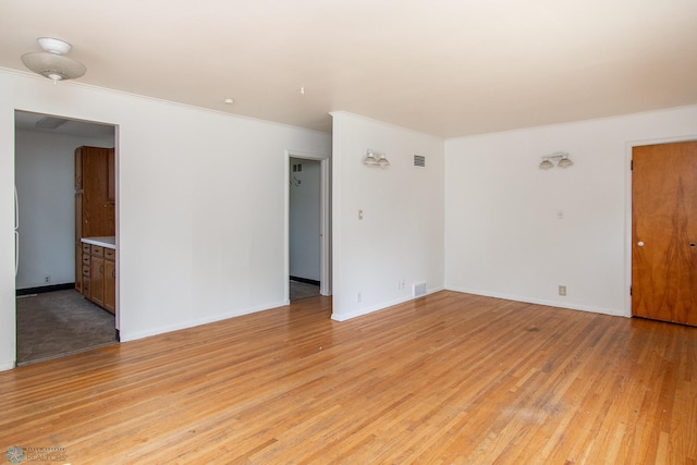 1614 2nd St N, Fargo, ND 58102 - spare room with crown molding, light wood-style flooring, and baseboards