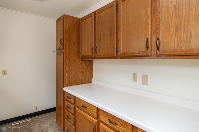 1614 2nd St N, Fargo, ND 58102 - kitchen with brown cabinets, baseboards, light countertops, and ornamental molding