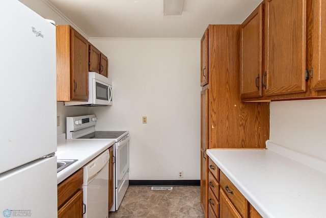 1614 2nd St N, Fargo, ND 58102 - kitchen with white appliances, brown cabinets, baseboards, light countertops, and ornamental molding