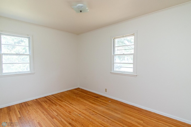 1614 2nd St N, Fargo, ND 58102 - unfurnished room with light wood finished floors, crown molding, and baseboards