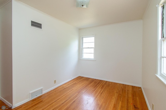1614 2nd St N, Fargo, ND 58102 - empty room featuring light wood-style flooring, crown molding, and baseboards
