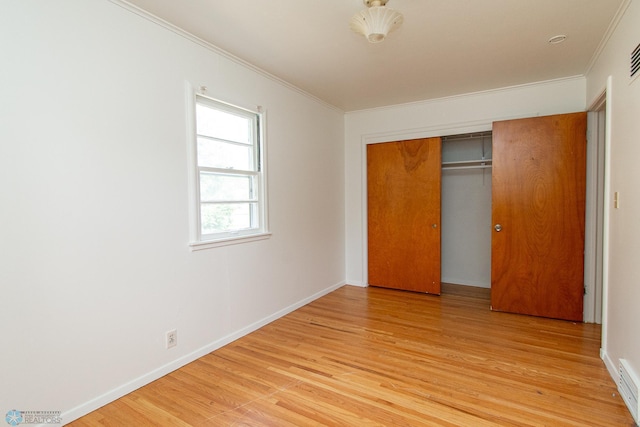 1614 2nd St N, Fargo, ND 58102 - unfurnished bedroom featuring crown molding, light wood-style flooring, a closet, and baseboards
