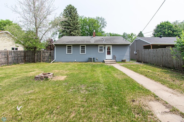 1614 2nd St N, Fargo, ND 58102 - back of house featuring entry steps, a fire pit, and a chimney