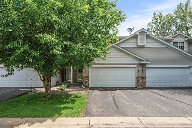 13408 Ximines Ln N, Champlin, MN 55316 - view of front of property featuring driveway, brick siding, and an attached garage
