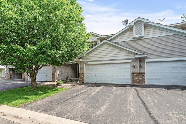 13408 Ximines Ln N, Champlin, MN 55316 - view of front of property featuring brick siding, asphalt driveway, and a garage