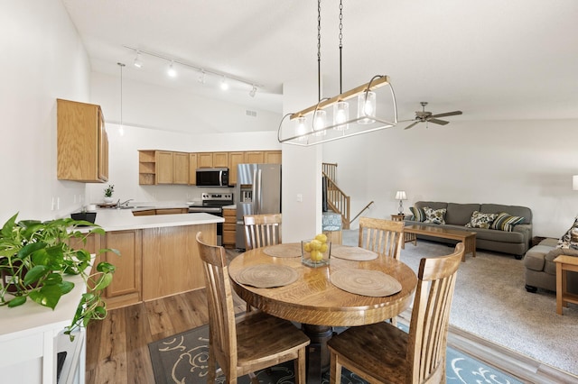 13408 Ximines Ln N, Champlin, MN 55316 - dining room with a high ceiling, a ceiling fan, stairs, light wood finished floors, and track lighting