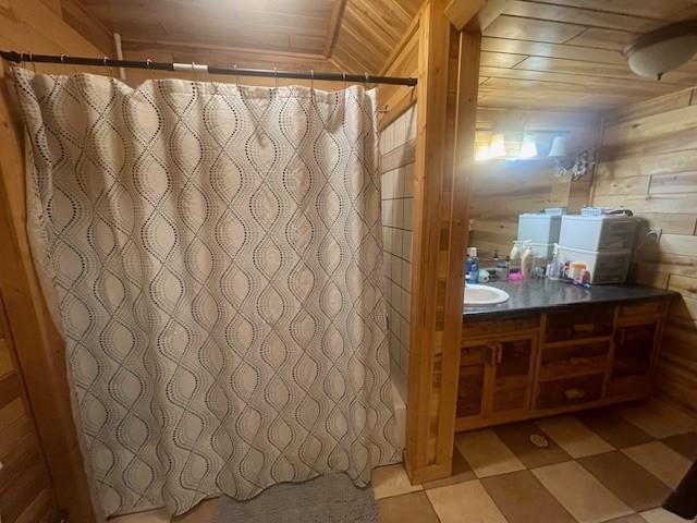 806 Central Ave N, Park Rapids, MN 56470 - bathroom with vanity, wood walls, a shower with shower curtain, and wooden ceiling