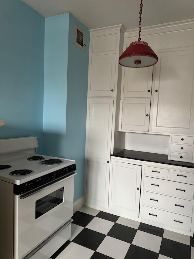 2615 Park Ave Unit 310, Minneapolis, MN 55407 - kitchen with white electric range oven, tile patterned floors, white cabinets, baseboards, and dark countertops