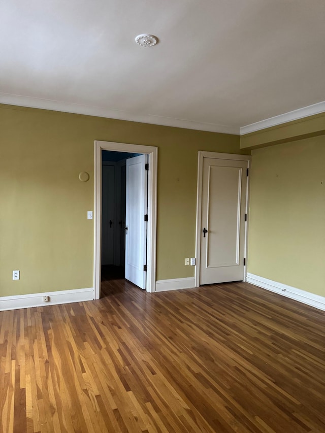 2615 Park Ave Unit 310, Minneapolis, MN 55407 - unfurnished room featuring baseboards, wood finished floors, and crown molding