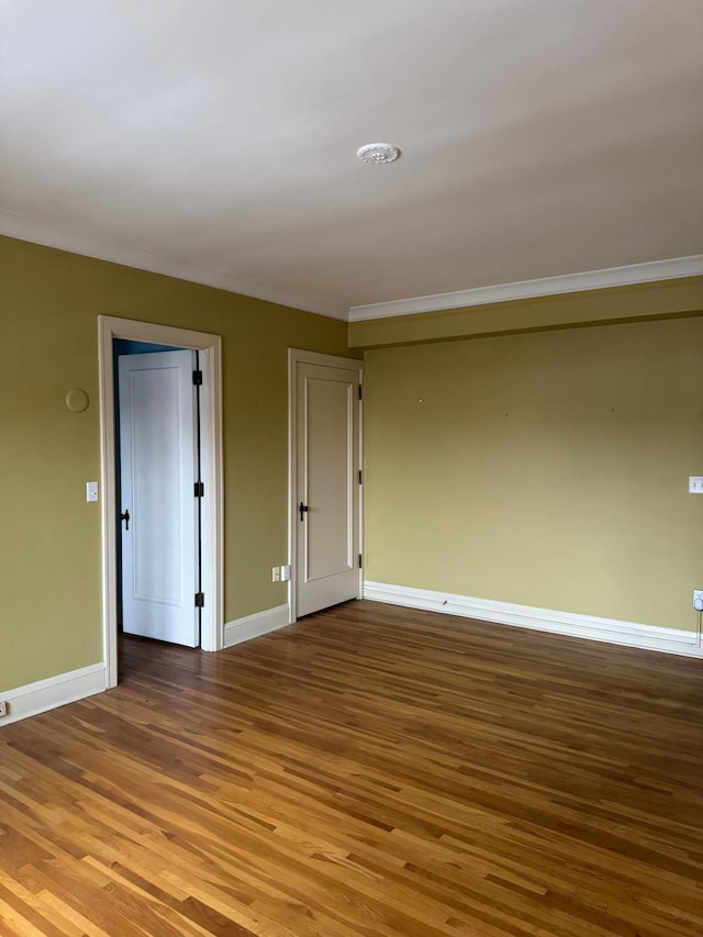 2615 Park Ave Unit 310, Minneapolis, MN 55407 - spare room featuring wood finished floors, crown molding, and baseboards