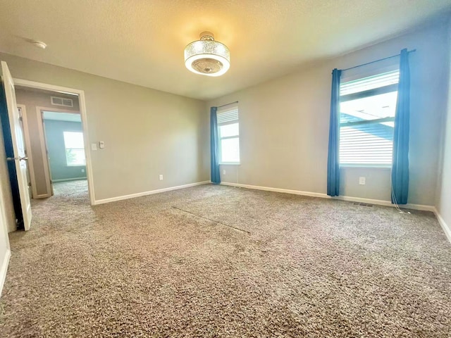 8521 Titanium Cir, Woodbury, MN 55129 - carpeted empty room with baseboards and a textured ceiling