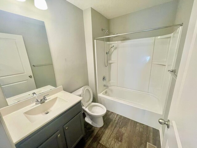 8521 Titanium Cir, Woodbury, MN 55129 - full bath featuring wood finished floors, toilet, vanity, and bathing tub / shower combination