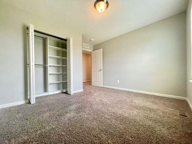 8521 Titanium Cir, Woodbury, MN 55129 - unfurnished bedroom with carpet, baseboards, and a closet