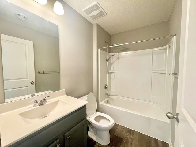 8521 Titanium Cir, Woodbury, MN 55129 - full bathroom featuring wood finished floors, vanity, toilet, shower / bathtub combination, and a textured ceiling