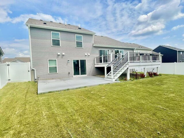 8521 Titanium Cir, Woodbury, MN 55129 - back of property featuring a patio area, a wooden deck, stairs, and a gate