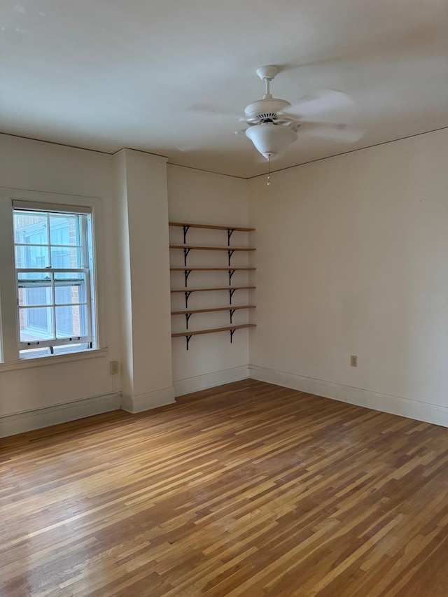 2615 Park Ave Unit 320, Minneapolis, MN 55407 - spare room featuring wood finished floors, ceiling fan, and baseboards