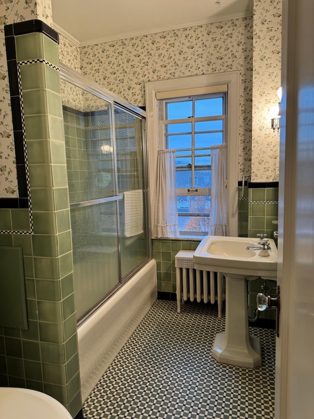 2615 Park Ave Unit 320, Minneapolis, MN 55407 - full bath featuring wallpapered walls, ornamental molding, tile walls, combined bath / shower with glass door, and toilet
