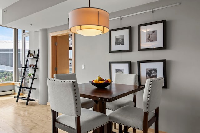 215 10th Ave S Unit 730, Minneapolis, MN 55415 - dining room featuring light wood-style flooring and baseboards