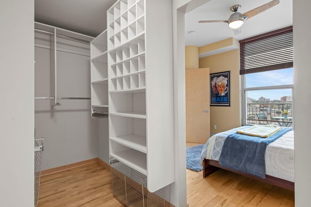 215 10th Ave S Unit 730, Minneapolis, MN 55415 - walk in closet featuring wood finished floors and a ceiling fan