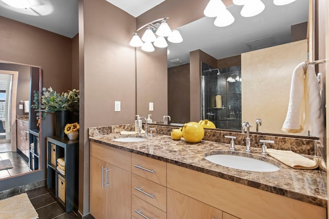 215 10th Ave S Unit 730, Minneapolis, MN 55415 - bathroom featuring double vanity, a tile shower, and tile patterned flooring