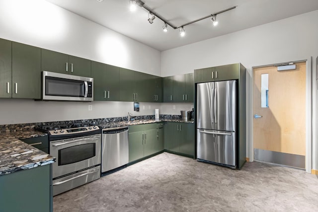 215 10th Ave S Unit 730, Minneapolis, MN 55415 - kitchen with appliances with stainless steel finishes, green cabinetry, track lighting, and dark stone counters