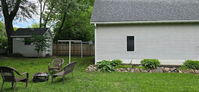 526 Mound St, Owatonna, MN 55060 - view of yard featuring a fire pit and a storage unit