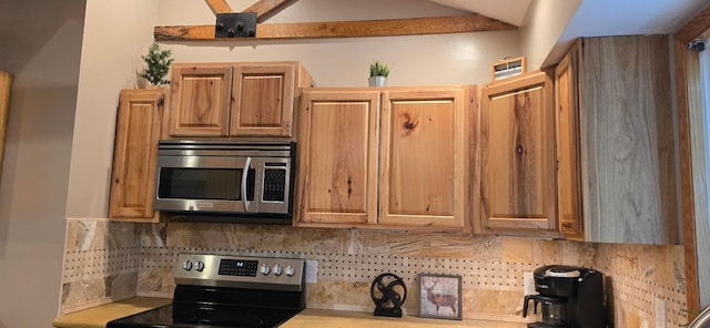 526 Mound St, Owatonna, MN 55060 - kitchen with appliances with stainless steel finishes, backsplash, lofted ceiling, and light countertops