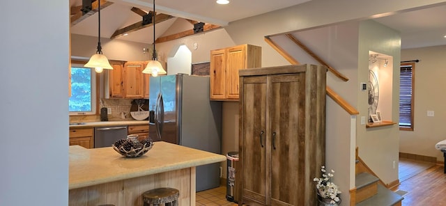 526 Mound St, Owatonna, MN 55060 - kitchen featuring appliances with stainless steel finishes, tasteful backsplash, light countertops, decorative light fixtures, and recessed lighting