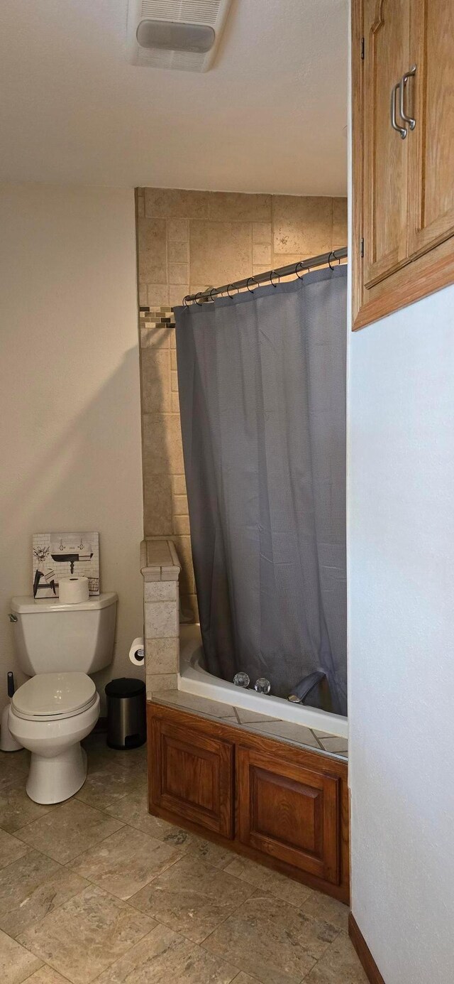 526 Mound St, Owatonna, MN 55060 - full bathroom featuring shower / bath combo with shower curtain and stone finish flooring
