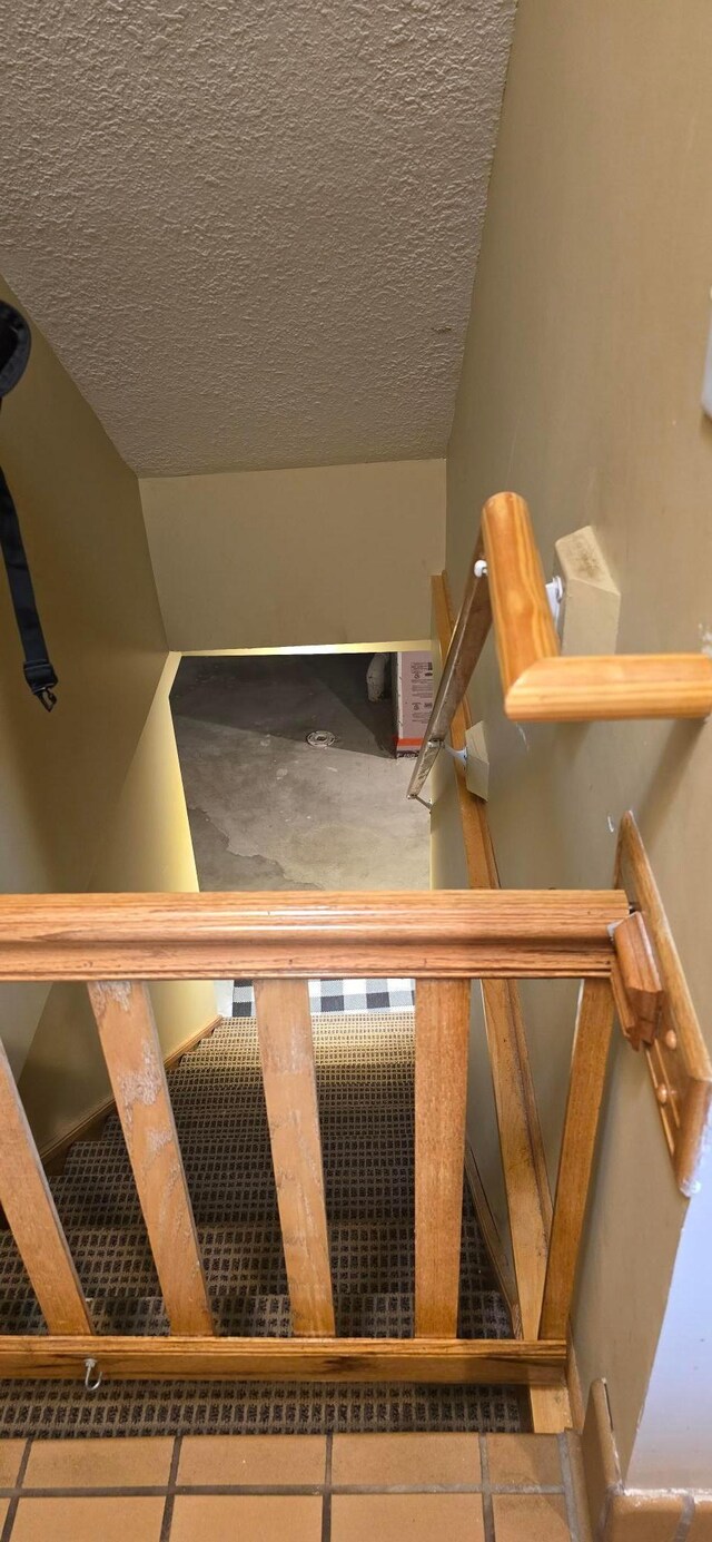 526 Mound St, Owatonna, MN 55060 - staircase featuring a textured ceiling