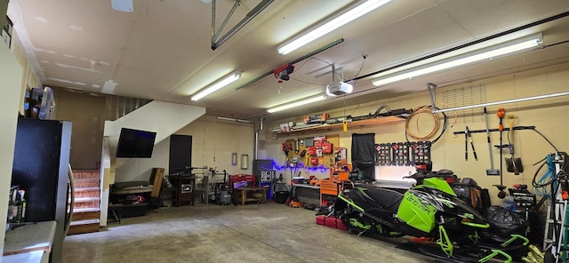 526 Mound St, Owatonna, MN 55060 - garage with a garage door opener and a workshop area