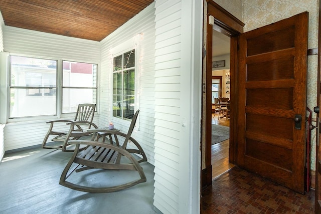 1023 Avon St N, Saint Paul, MN 55103 - sunroom with wooden ceiling, wallpapered walls, and brick patterned flooring