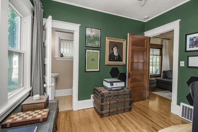 1023 Avon St N, Saint Paul, MN 55103 - bedroom with light wood finished floors and crown molding