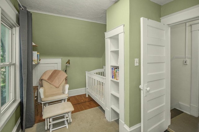 1023 Avon St N, Saint Paul, MN 55103 - bedroom with a crib and wood finished floors