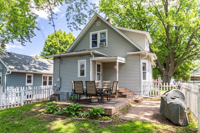 1023 Avon St N, Saint Paul, MN 55103 - rear view of property featuring a chimney, a deck, outdoor dining space, and cooling unit