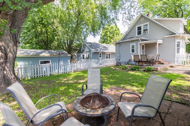 1023 Avon St N, Saint Paul, MN 55103 - rear view of property with an outdoor fire pit, a fenced backyard, a patio area, and a chimney