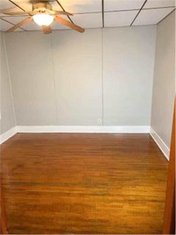 587 Bay St, Saint Paul, MN 55102 - unfurnished room featuring wood finished floors, a drop ceiling, and a ceiling fan