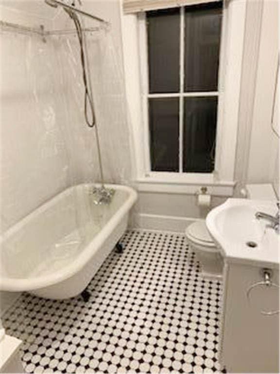 587 Bay St, Saint Paul, MN 55102 - bathroom featuring a freestanding tub, tile patterned flooring, vanity, and a shower