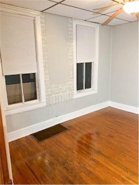587 Bay St, Saint Paul, MN 55102 - unfurnished room featuring wood finished floors and a paneled ceiling